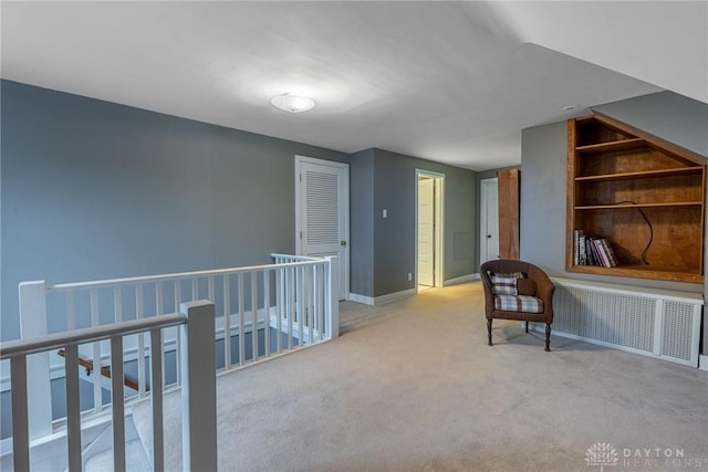 interior space featuring radiator heating unit and light colored carpet