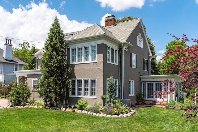 view of side of property featuring cooling unit and a lawn