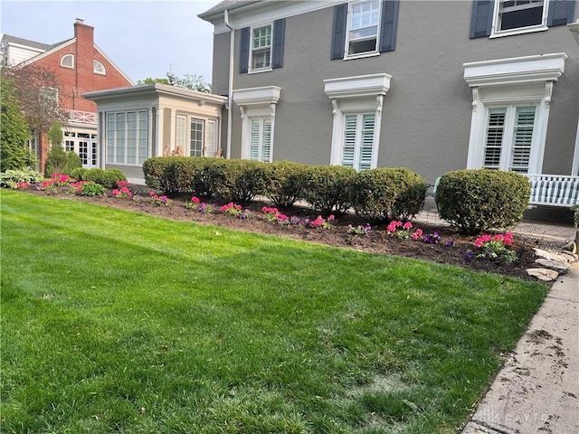 view of property exterior featuring a lawn