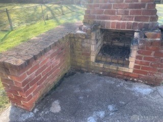 exterior details featuring a fireplace