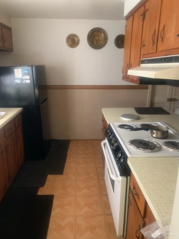 kitchen with white range with electric cooktop and refrigerator