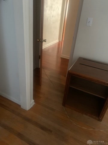 hallway with hardwood / wood-style floors