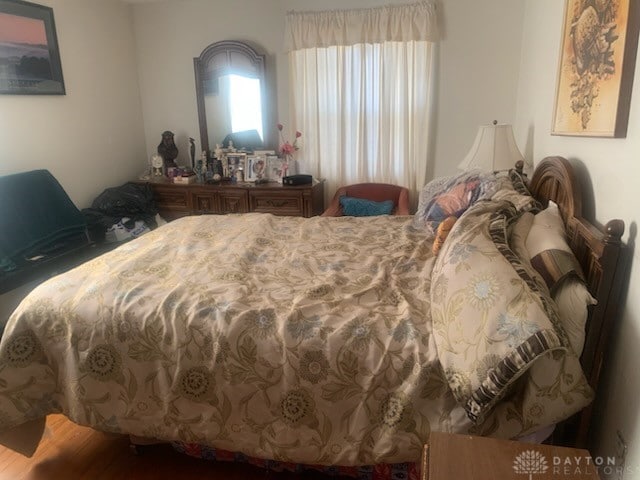 bedroom with hardwood / wood-style flooring