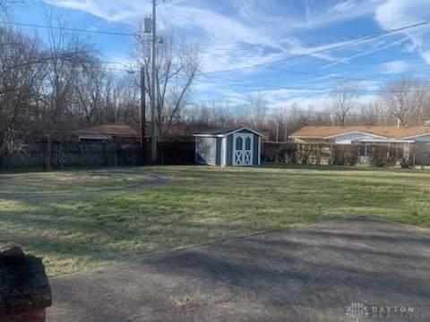 view of yard with a shed and a patio area