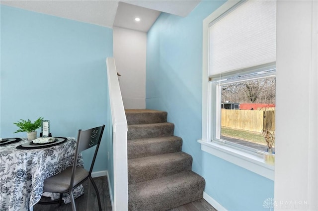 stairway featuring baseboards and wood finished floors