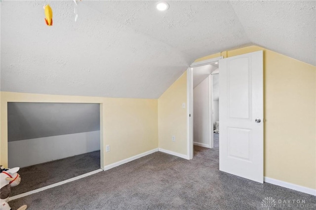 bonus room featuring carpet floors, baseboards, vaulted ceiling, and a textured ceiling