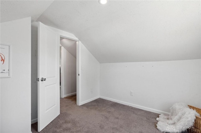 bonus room with carpet flooring, vaulted ceiling, a textured ceiling, and baseboards