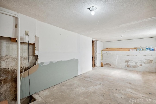 unfinished basement with a textured ceiling