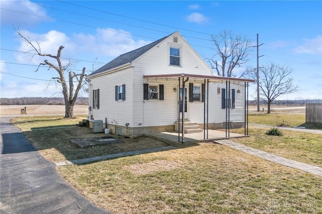 bungalow featuring entry steps, a front lawn, and central AC unit