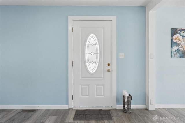 entryway with wood finished floors, visible vents, and baseboards