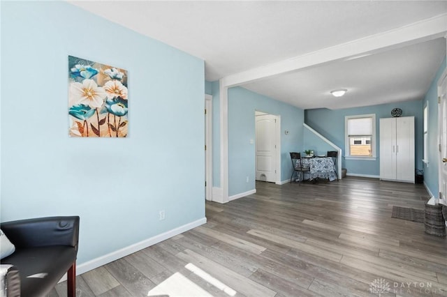 living area with baseboards and wood finished floors