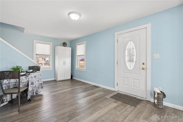 entrance foyer with wood finished floors and baseboards