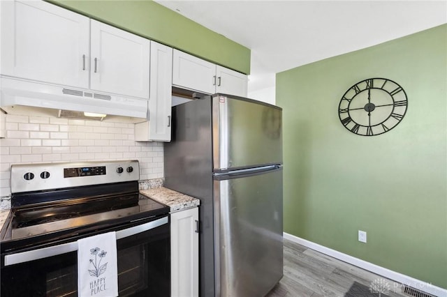 kitchen with tasteful backsplash, baseboards, stainless steel appliances, under cabinet range hood, and white cabinetry