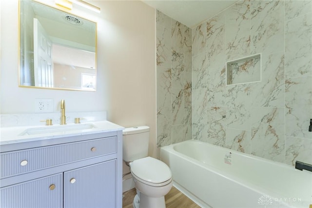 bathroom with hardwood / wood-style flooring, vanity, and toilet