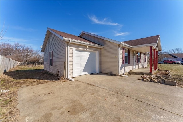 view of side of home with a porch and a garage