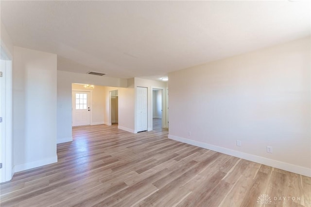 spare room with light hardwood / wood-style flooring