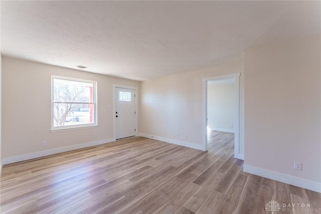 empty room with light hardwood / wood-style floors