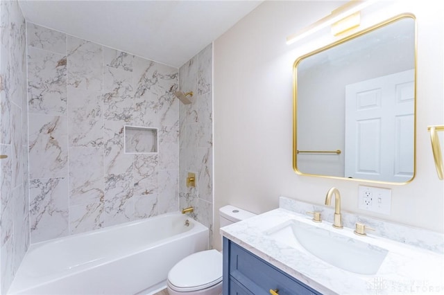 full bathroom with vanity, toilet, and tiled shower / bath