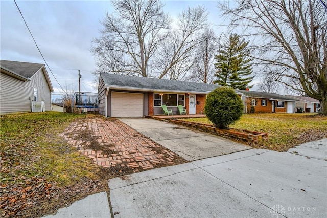 single story home with a garage, concrete driveway, and brick siding