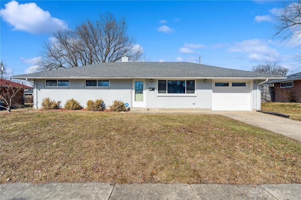 ranch-style home featuring a garage and a front yard