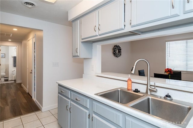 kitchen featuring sink and light tile patterned floors