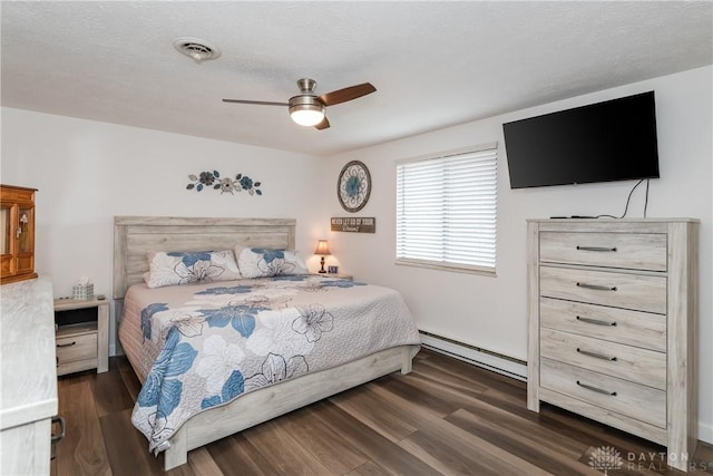 bedroom featuring ceiling fan, a baseboard radiator, dark hardwood / wood-style floors, and a textured ceiling