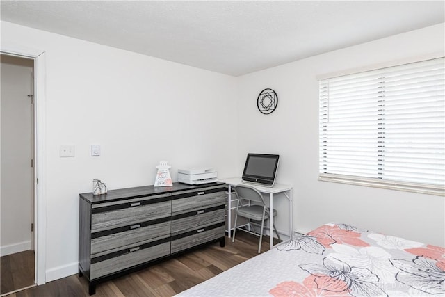 bedroom with dark hardwood / wood-style flooring