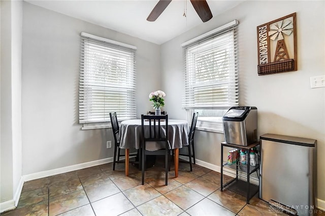 tiled dining room featuring baseboards and a ceiling fan