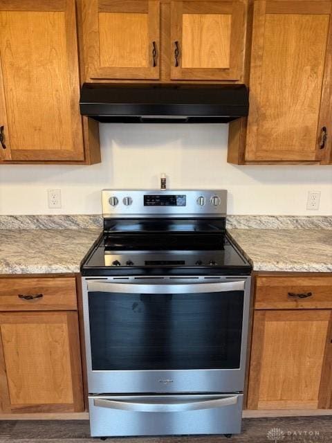 kitchen featuring electric stove and light stone countertops