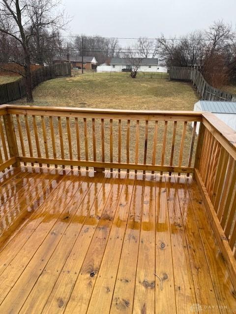 wooden terrace with a lawn