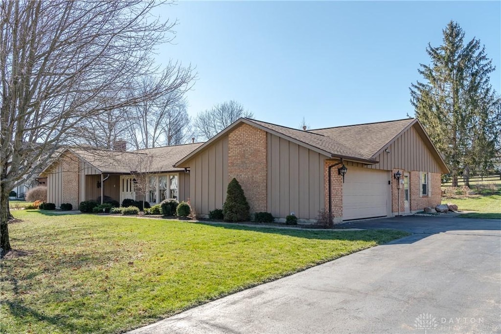 view of property exterior featuring a yard and a garage