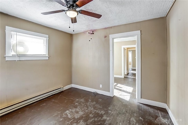spare room featuring dark hardwood / wood-style floors, ceiling fan, a baseboard heating unit, and a textured ceiling
