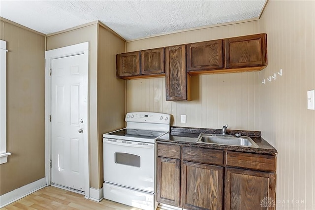 kitchen with sink, a textured ceiling, white range with electric stovetop, and light hardwood / wood-style flooring