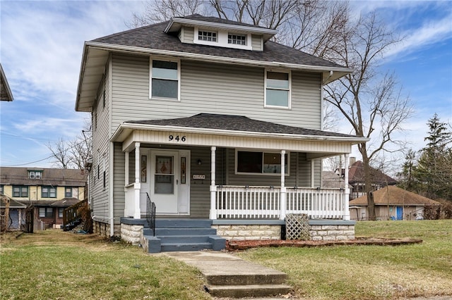 view of front of home with covered porch and a front lawn