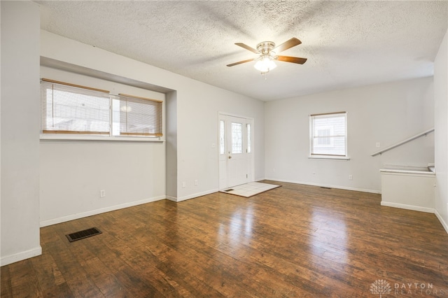 spare room featuring ceiling fan, a textured ceiling, and dark hardwood / wood-style flooring