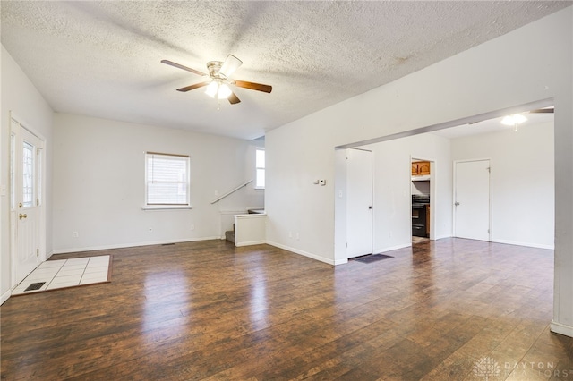 interior space featuring ceiling fan, dark hardwood / wood-style floors, and a textured ceiling