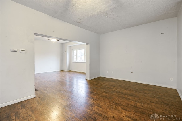 unfurnished room featuring dark hardwood / wood-style floors and a textured ceiling