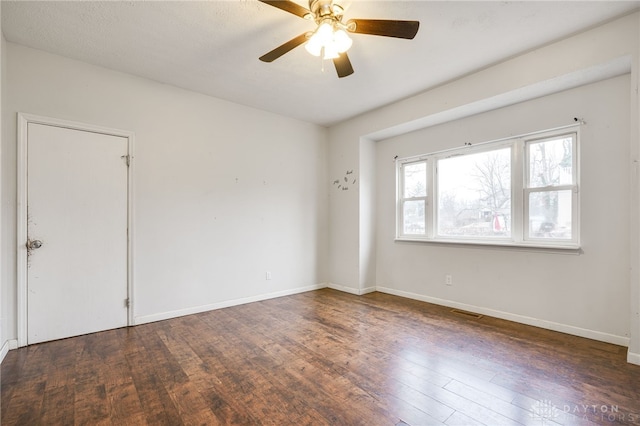 unfurnished room with ceiling fan and dark hardwood / wood-style floors