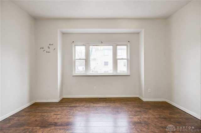 spare room featuring dark hardwood / wood-style floors