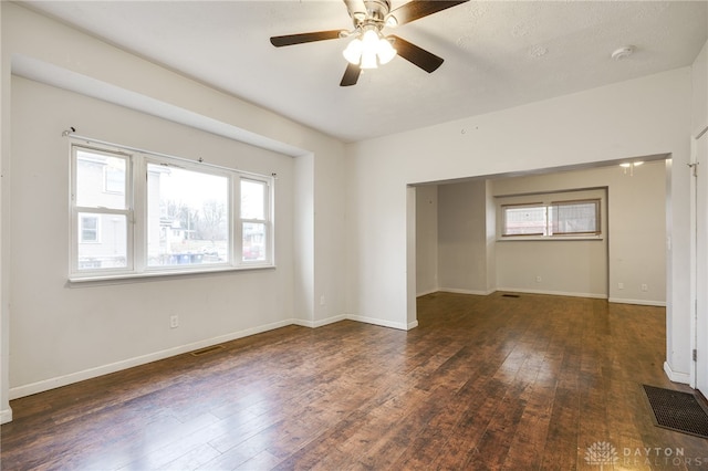 unfurnished room featuring dark wood-type flooring and ceiling fan