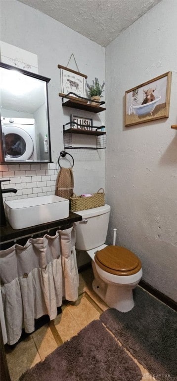 bathroom with sink, a textured ceiling, and toilet