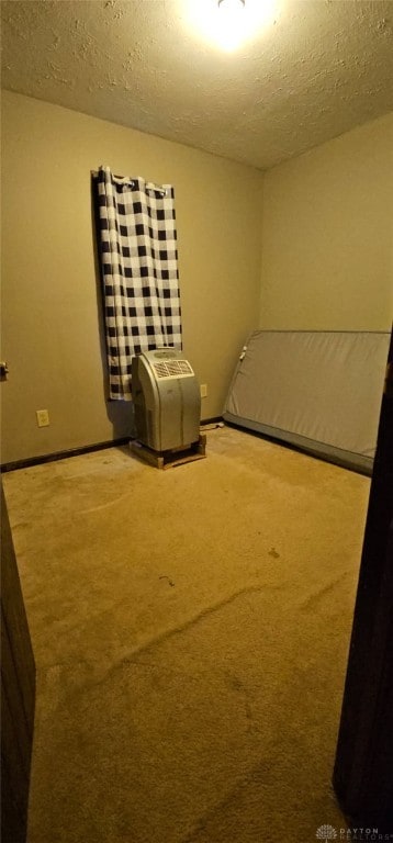 unfurnished bedroom featuring carpet and a textured ceiling