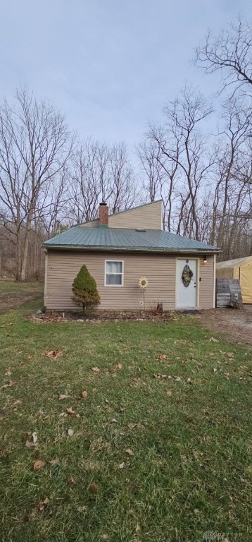 view of outbuilding featuring a yard