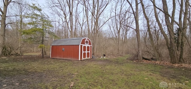 view of shed with a view of trees