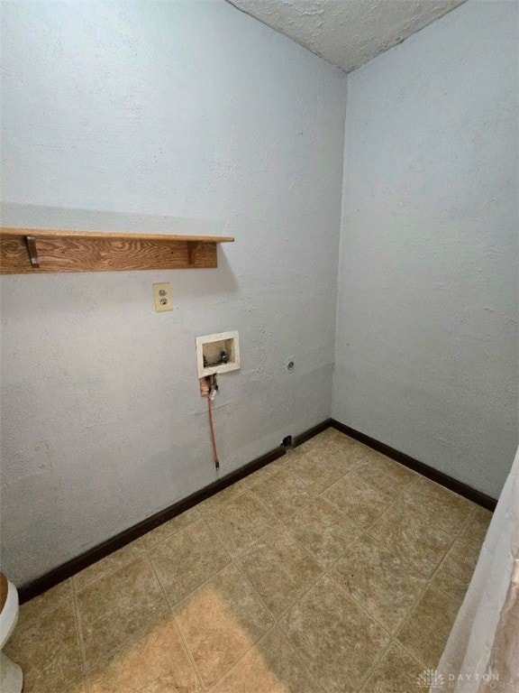 washroom featuring electric dryer hookup, hookup for a washing machine, laundry area, and baseboards