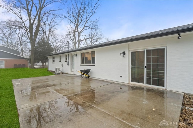 rear view of property with a patio, a yard, and central air condition unit