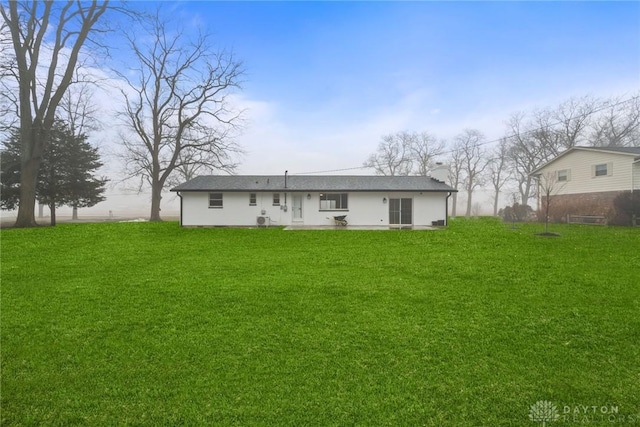 rear view of property with a yard