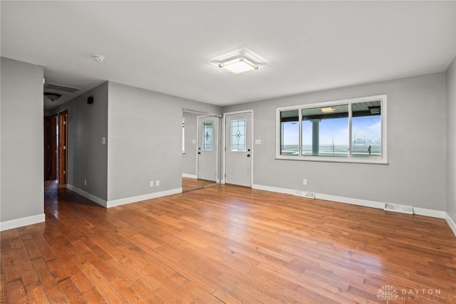 unfurnished room with hardwood / wood-style flooring