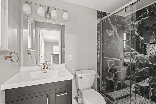 bathroom with vanity, toilet, and an enclosed shower