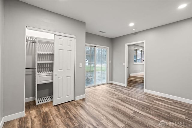 interior space featuring dark wood-type flooring, a closet, and access to outside